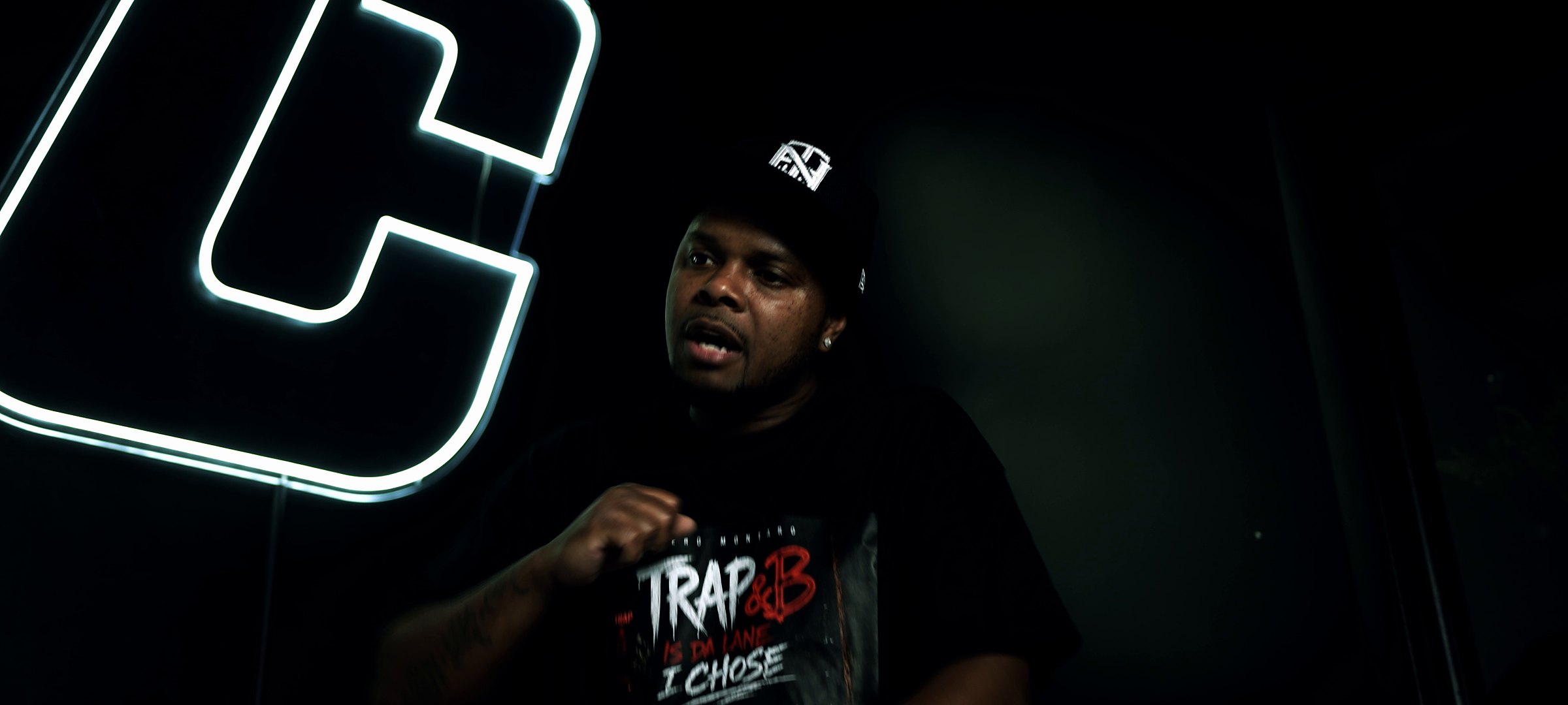 Dinero Montaro under neon lights in the Trap&amp;B Is Da Lane I Chose tee